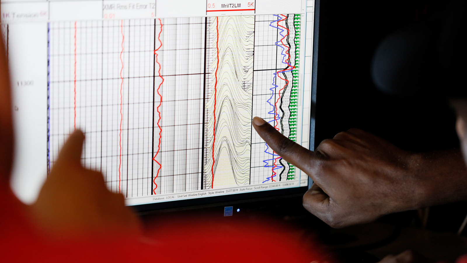 Halliburton engineer with hard hat smiling at camera